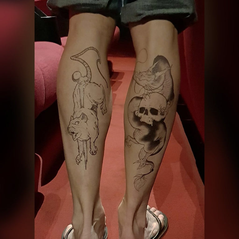 Tatouage temporaire hyperréaliste Large Dragon Skull - by Le Kid de ArtWear Tattoo Collaborations sur le bras d'un homme et jambe d'une femme