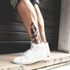 Tatouage temporaire hyperréaliste Biomechanical 1 - White Touch de ArtWear Tattoo Cartoon sur le bras d'un homme et jambe d'une femme