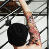 Tatouage temporaire hyperréaliste Red Dragon Sleeve de ArtWear Tattoo Old School sur le bras d'un homme et jambe d'une femme